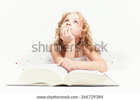 Beautiful little girl thinks about read in the book.