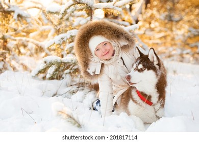beautiful little girl in winter forest with dog