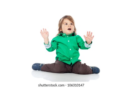 Beautiful little kid, 2 years old boy, sitting on the floor with hands up, wearing shirt and jeans. High resolution image isolated on white background with copy space. Studio shot.