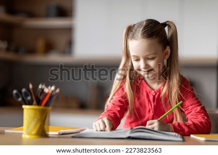 Beautiful Little Preteen Girl Writing With Pencil In Notebook While Sitting At Desk At Home, Portrait Of Cute Caucasian Female Child Drawing In Workbook, Doing School Homework, Copy Space