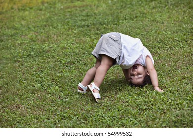 Beautiful Little Toddler Tumbling In Grass