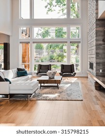 Beautiful Living Room With Hardwood Floors And Fireplace In New Luxury Home