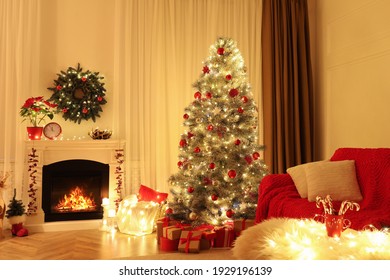 Beautiful Living Room Interior With Burning Fireplace And Christmas Tree In Evening