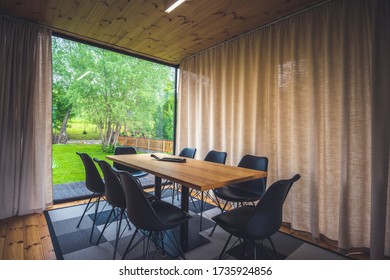 Beautiful Living Room Interior. Large Bank Of Windows Hints At Exterior View. Small Wood Bungalow With Luxury Furniture.