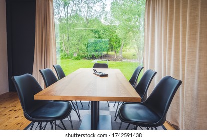 Beautiful Living Room Interior. Large Bank Of Windows Hints At Exterior View. Small Wood Bungalow With Luxury Furniture.