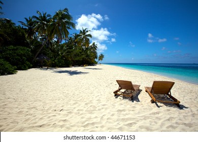 Beautiful lonely beach with chairs