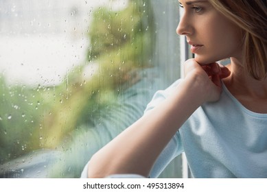 Beautiful Lonely Woman Sitting In Front Of Window