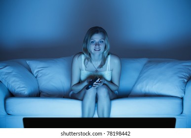 Beautiful Lonely Woman Sitting On Couch And Watching Tv