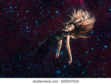 Beautiful, long haired woman falling through stars in space, elements of this image furnished by NASA