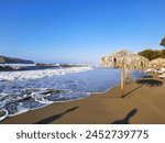 A beautiful long sandy beach in the resort of Agia Marina on the Greek island of Crete in Europe. The beach is also suitable for walking. Great for families with children.