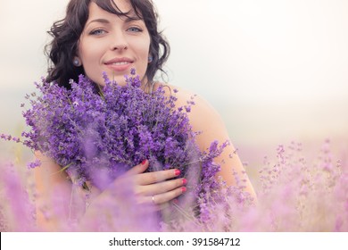Beautiful long-haired brunette in a lavender field