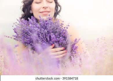 Beautiful long-haired brunette in a lavender field