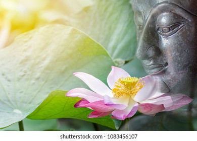Beautiful of lotus flower and buddha image put together look like art . On the face of buddha has a little smiley. Buddhism in Thailand is popular. The  culture of Thailand involved buddha.