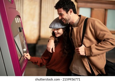 Beautiful Loving Couple Buying Train Ticket At Self Service Vending Machine On The Station. Happy Woman And Man Travel Together.	