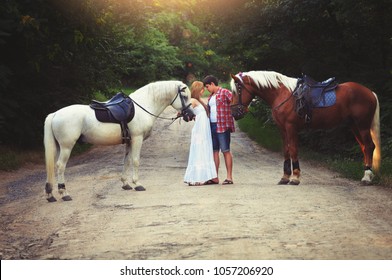 Beautiful Loving Couple With Horses Stand In The Woods On The Road, Cozy And Warm Artistic Image, Flying Bright Day.