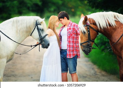 Beautiful Loving Couple With Horses Stand In The Woods On The Road, Cozy And Warm Artistic Image, Flying Bright Day.