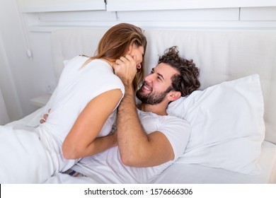 Beautiful loving couple kissing in bed. beautiful young couple lying together on the bed. - Powered by Shutterstock