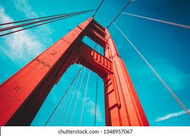 Beautiful low angle view of famous Golden Gate Bridge with blue sky and clouds on a sunny day in summer with retro vintage post crocessing filter effect, San Francisco Bay Area, California, USA - Powered by Shutterstock