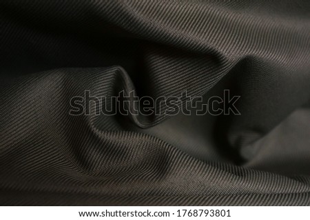 beautiful luxurious shadow khaki fabric background, detail of wavy opaque fabric background, closeup crumpled textile shiny khaki color