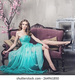 Beautiful Luxurious Woman On A Vintage Couch