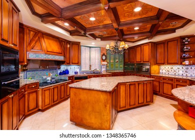 Beautiful Luxury Home Kitchen With Red Cherry Wood Cabinets.