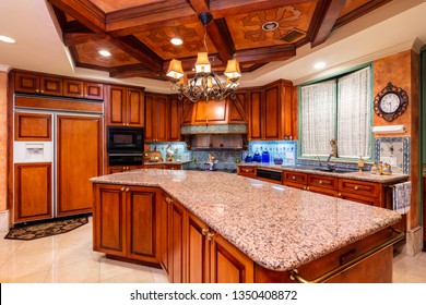 Beautiful Luxury Home Kitchen With Red Cherry Wood Cabinets.