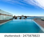 Beautiful luxury hotel W Barcelona at Barceloneta Beach with an overview of their stunning pool area and the beach in the background