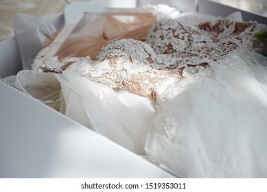 Beautiful Luxury Wedding Dress In White Box On Bed, Copy Space. Bridal Morning Preparations. Wedding Concept