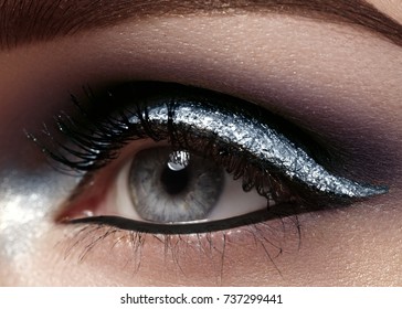 Beautiful Macro Shot Of Female Eye With Ceremonial Makeup. Perfect Shape Of Eyebrows, Eyeliner And Pretty Silver Line On Eyelid. Cosmetics And Make-up. Closeup Macro Shot Of Fashion Sparcle Visage