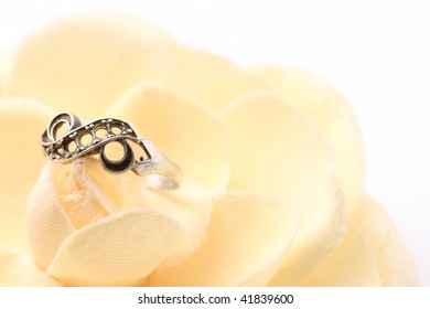 Beautiful macro shot of a ring on a soft flower. Good for wedding products.