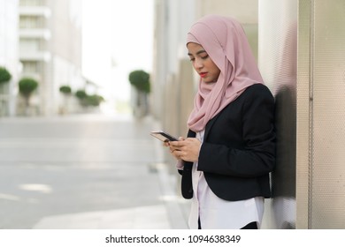 Beautiful Malay Girl Holding Mobile Phone Outdoor