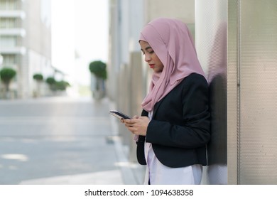 Beautiful Malay Girl Holding Mobile Phone Outdoor