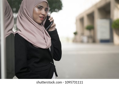 Beautiful Malay Girl Holding Mobile Phone Outdoor