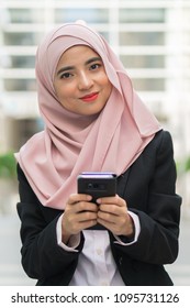 Beautiful Malay Girl Holding Mobile Phone Outdoor