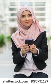 Beautiful Malay Girl Holding Mobile Phone Outdoor