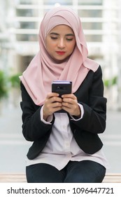 Beautiful Malay Girl Holding Mobile Phone Outdoor