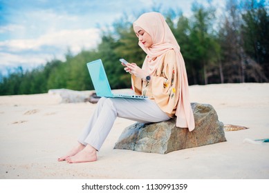 Beautiful Malay Woman Using Latest Mobile Phone Feature Finger Print