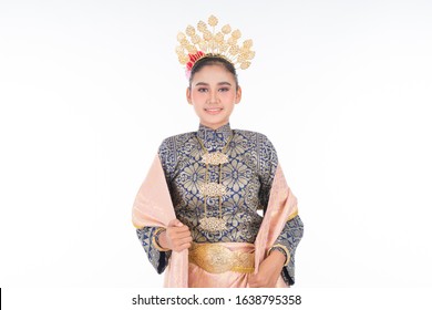 A beautiful Malaysian traditional female dancer wearing traditional dance outfit. Half length portrait isolated in white. Landscape orientation.
