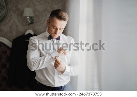 Beautiful man, groom posing and preparing for wedding