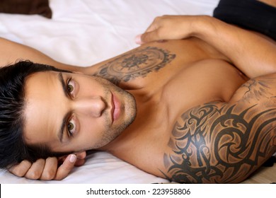 Beautiful Man Lying On A Bed