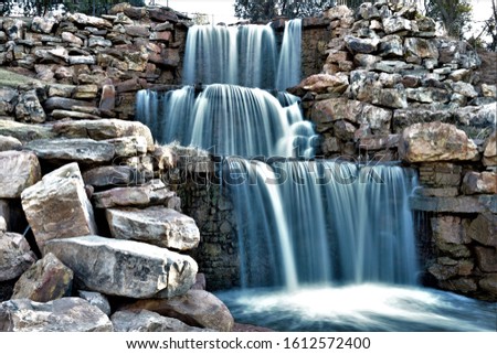 Beautiful man made waterfall surrounded by small boulders in Wichita Falls Texas