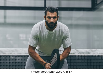 Beautiful Man Playing Paddle Tennis, Racket In Hand   Concentrated Look. Young Sporty Boy Ready For The Match. Focused Padel Athlete Ready To Receive The Ball. Sport, Health, Youth And Leisure Concept