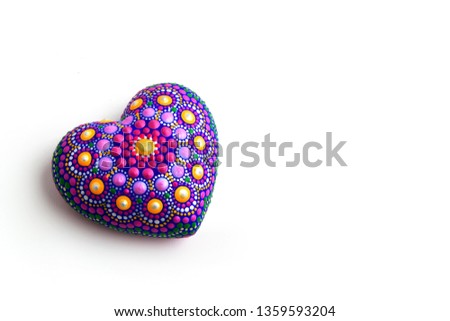 Beautiful mandala hand painted on plaster heart, isolated on white background