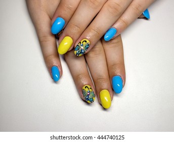 Beautiful Manicure With Yellow And Blue Nails And Painted With Volumetric Butterfly And Rhinestone