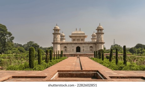 Beautiful marble tomb of Itmad-Ud-Daulah  against the blue sky. Symmetrical mausoleum with domes, minarets, arches. There are ornaments on the walls, inlaid with precious stones. India. Agra - Shutterstock ID 2282602851