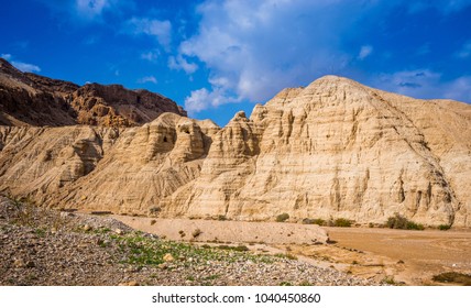 Beautiful marlstone cliffs of Qumran caves  - archaeological site, where the Hebrew Bible manuscripts, called the Dead Sea Scrolls have been discovered, and a Judean Desert wadi; Israel