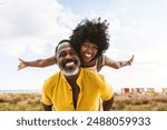 Beautiful mature black couple of lovers dating at the seaside - Married african middle-aged couple bonding and having fun outdoors, concepts about relationship, lifestyle and quality of life