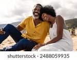 Beautiful mature black couple of lovers dating at the seaside - Married african middle-aged couple bonding and having fun outdoors, concepts about relationship, lifestyle and quality of life