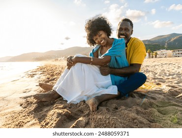 Beautiful mature black couple of lovers dating at the seaside - Married african middle-aged couple bonding and having fun outdoors, concepts about relationship, lifestyle and quality of life - Powered by Shutterstock