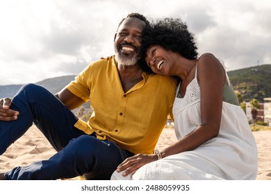 Beautiful mature black couple of lovers dating at the seaside - Married african middle-aged couple bonding and having fun outdoors, concepts about relationship, lifestyle and quality of life - Powered by Shutterstock